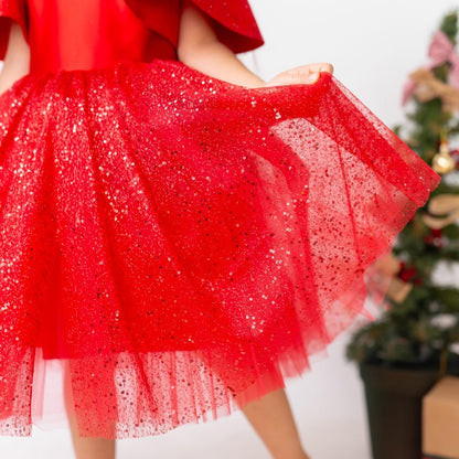 Close-up of sparkly red tulle skirt on red satin flower girl dress