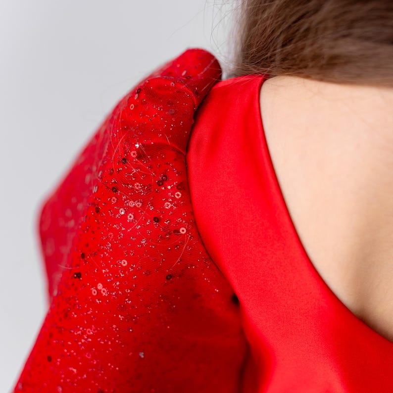 Button closure detail on back of red satin flower girl dress