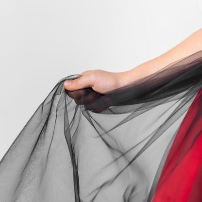 Close-up of the black tulle overlay on a red and black sparkly Christmas holiday flower girl dress, showing sheer layered fabric.