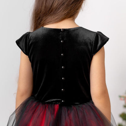 Back view of red and black velvet flower girl dress with button closure and layered tulle skirt