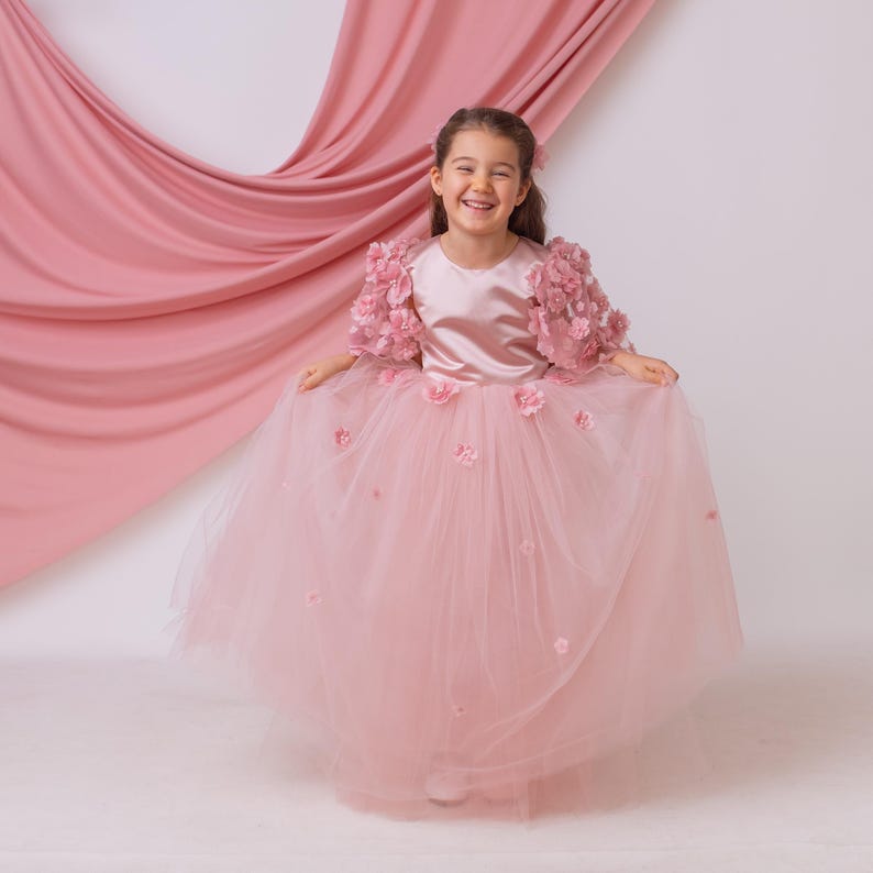 Blush satin flower girl dress featuring a flowing tulle skirt and delicate floral details, classic girls dress for weddings and formal events