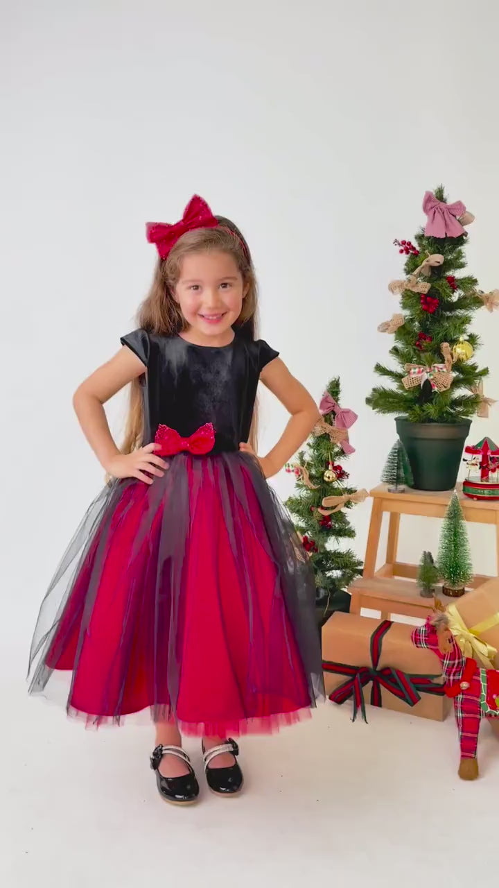 Video showing red and black velvet flower girl dress in motion with layered tulle skirt and styling details
